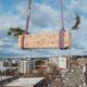 Last wood beam for heartwood, First Mass Timber Middle-Income Housing Development in U.S. being raised.