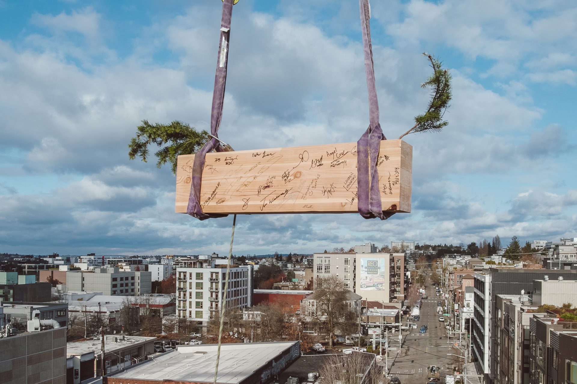 Last wood beam for heartwood, First Mass Timber Middle-Income Housing Development in U.S. being raised.